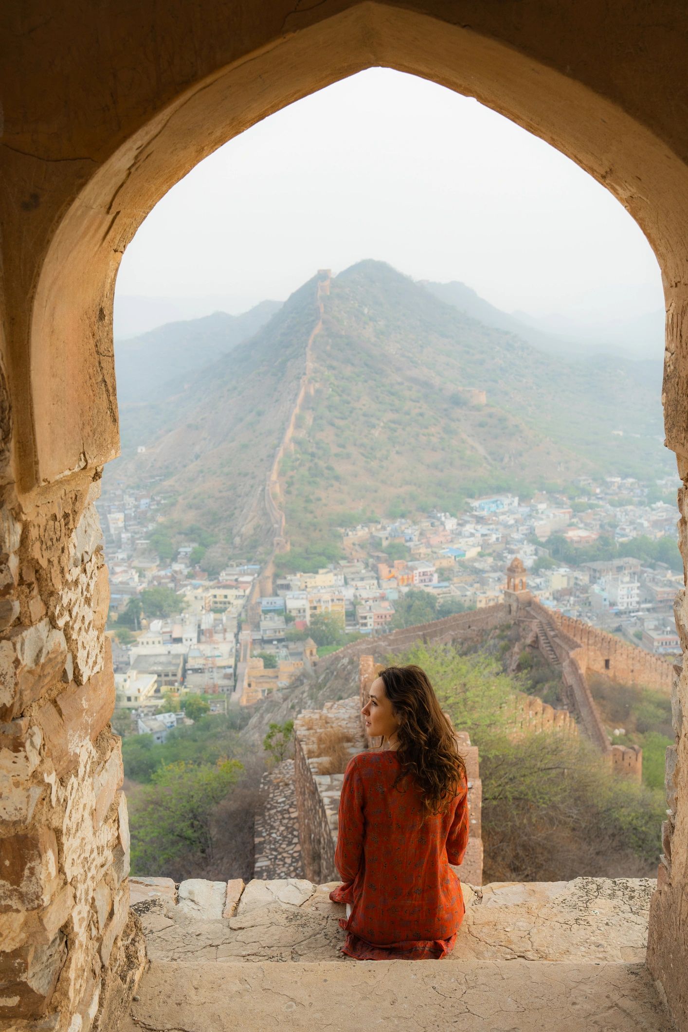 Woman looking over Jaipur at sunset