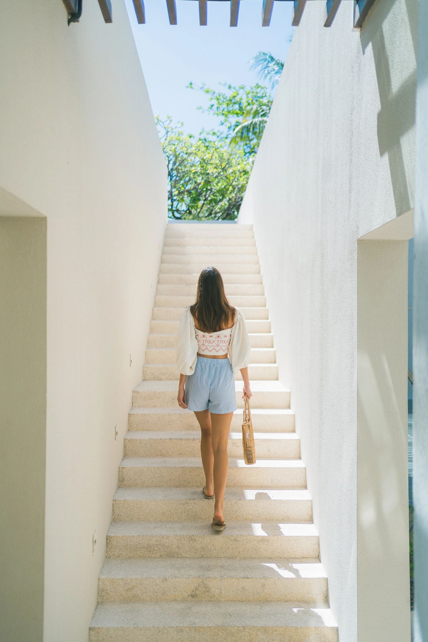 Woman walking through a tropical luxury resort