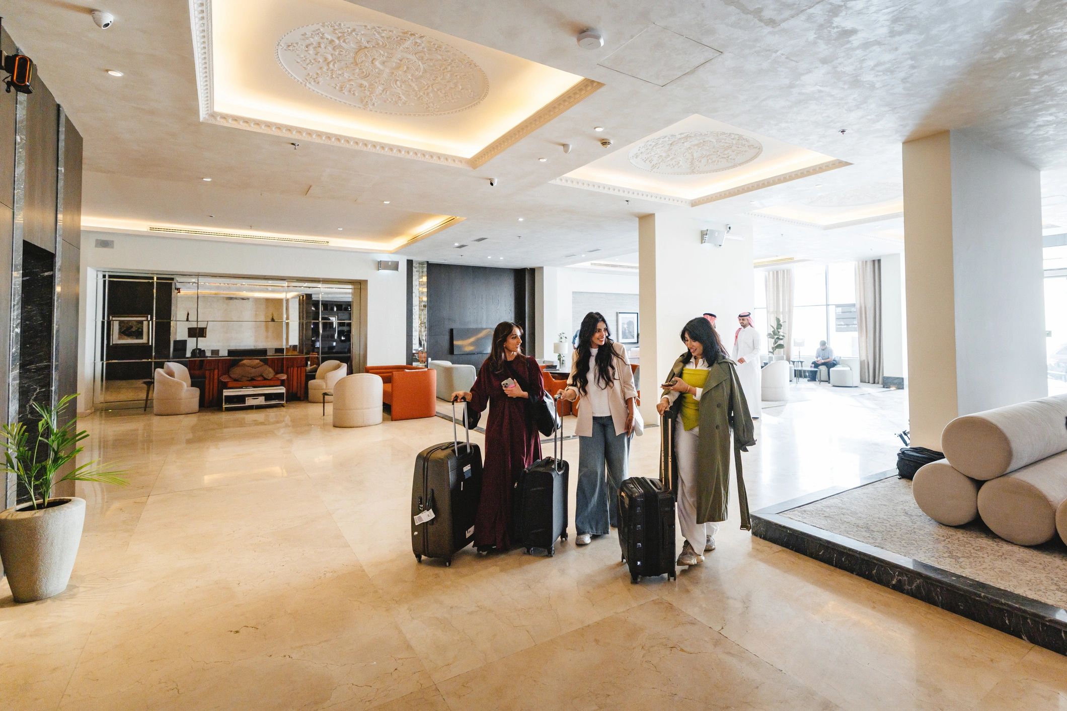 Friends arriving at a contemporary hotel with luggage